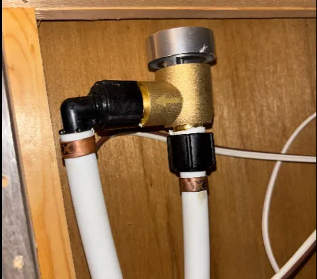 Upgraded brass RV plumbing vacuum breaker installed on PEX water lines during RV spring de-winterization and plumbing inspection in Harford County, Maryland.